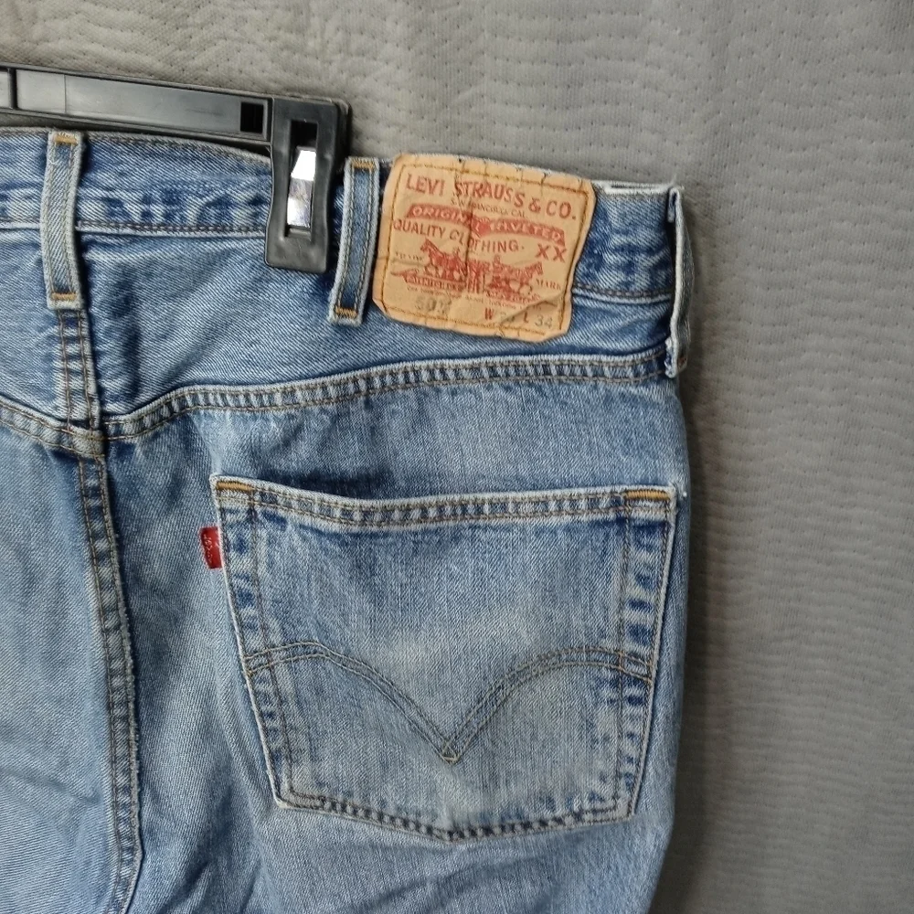Levis 501XX men's button fly blue jeans. Sz 38x34.tear in seat. See last pic. M2